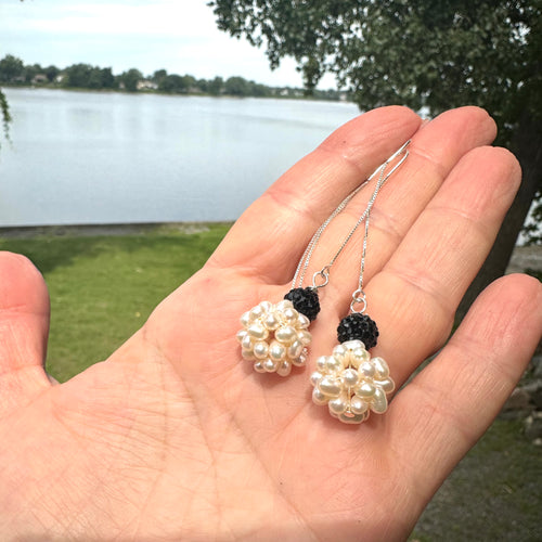 Freshwater pearl ball threader earrings featuring white ball pearls with black rhinestone pave polymer clay accents on top. The earrings are silver, long, and elegant, with a minimalist design that threads through the ear for a modern look