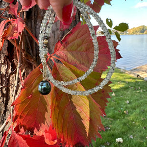 This necklace features a delicate chain of soft, translucent faceted green Prehnite rondelle beads, beautifully complemented by a striking Tahitian baroque pearl as the centerpiece pending from a cold filled toggle clasp. 18"inches long