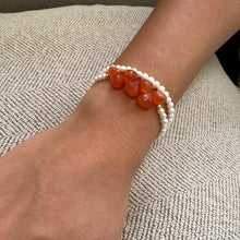 Load image into Gallery viewer, double wrap bracelet, featuring one long strand of lustrous freshwater pearls 4mm accented by stunning deep orange Carnelian Onion briolettes. Gold filled lobster clasp
