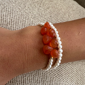 double wrap bracelet, featuring one long strand of lustrous freshwater pearls 4mm accented by stunning deep orange Carnelian Onion briolettes. Gold filled lobster clasp