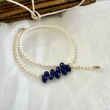 Cargar imagen en el visor de la galería, double wrap bracelet, featuring two strands of shimmering freshwater pearls beautifully accented with deep blue Lapis Lazuli teardrop briolettes, Gold filled details.
