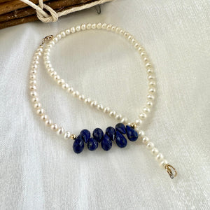 double wrap bracelet, featuring two strands of shimmering freshwater pearls beautifully accented with deep blue Lapis Lazuli teardrop briolettes, Gold filled details.