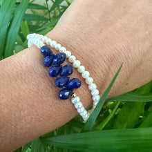 Cargar imagen en el visor de la galería, double wrap bracelet, featuring two strands of shimmering freshwater pearls beautifully accented with deep blue Lapis Lazuli teardrop briolettes, Gold filled details.
