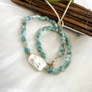 Fall in love with the soothing blues of Larimar and the timeless elegance of baroque pearls! This necklace features dreamy, ocean-inspired Larimar gemstones nuggets, perfectly complemented by the organic beauty of a stunning baroque pearl, 18 inches