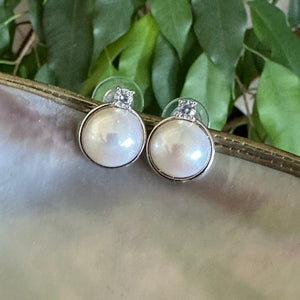 White Mabe Edison pearl stud earrings with CZ accents, set in sterling silver, minimalist and elegant, perfect for bridal jewelry or a special gift.