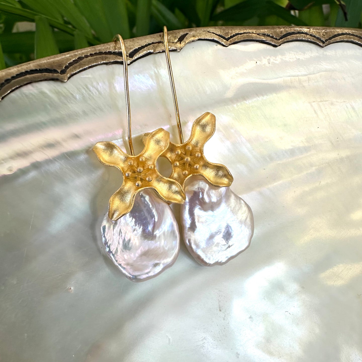 Large Petal pearls dangling gracefully from gold vermeil-plated silver fish hook settings in the shape of flowers