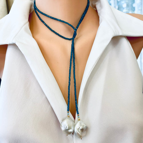 Single strand lariat necklace featuring faceted London blue quartz beads 3mm and two large baroque pearls, measuring 43 inches. This elegant piece is perfect as a December birthstone gift for her.